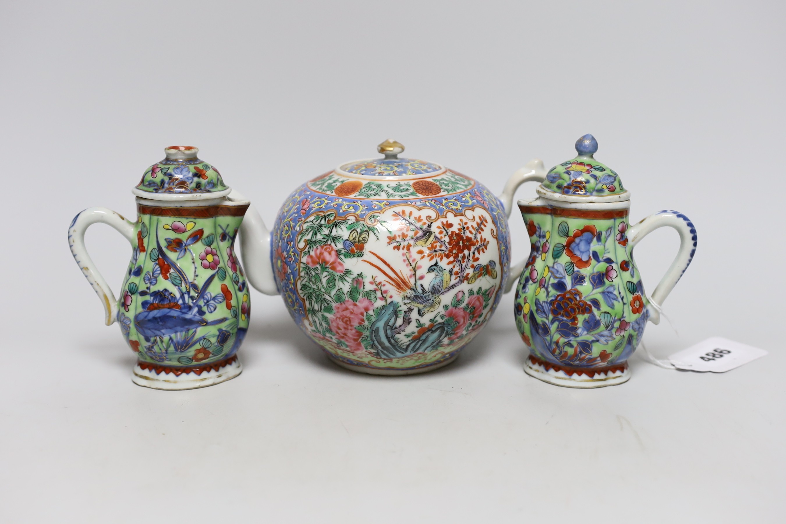 Two Chinese Kangxi clobbered jugs and covers, and a 19th century famille rose teapot, 13cms high
